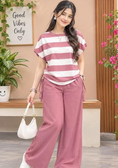 Simple gharelu girl in striped top and pink pants at home