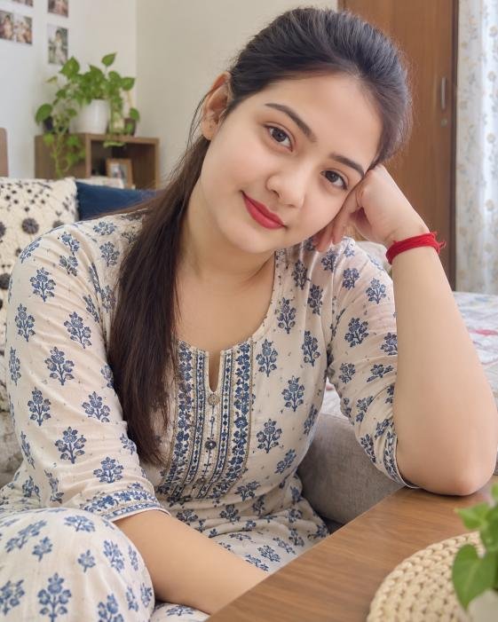 Simple Indian woman in soft daylight inside home